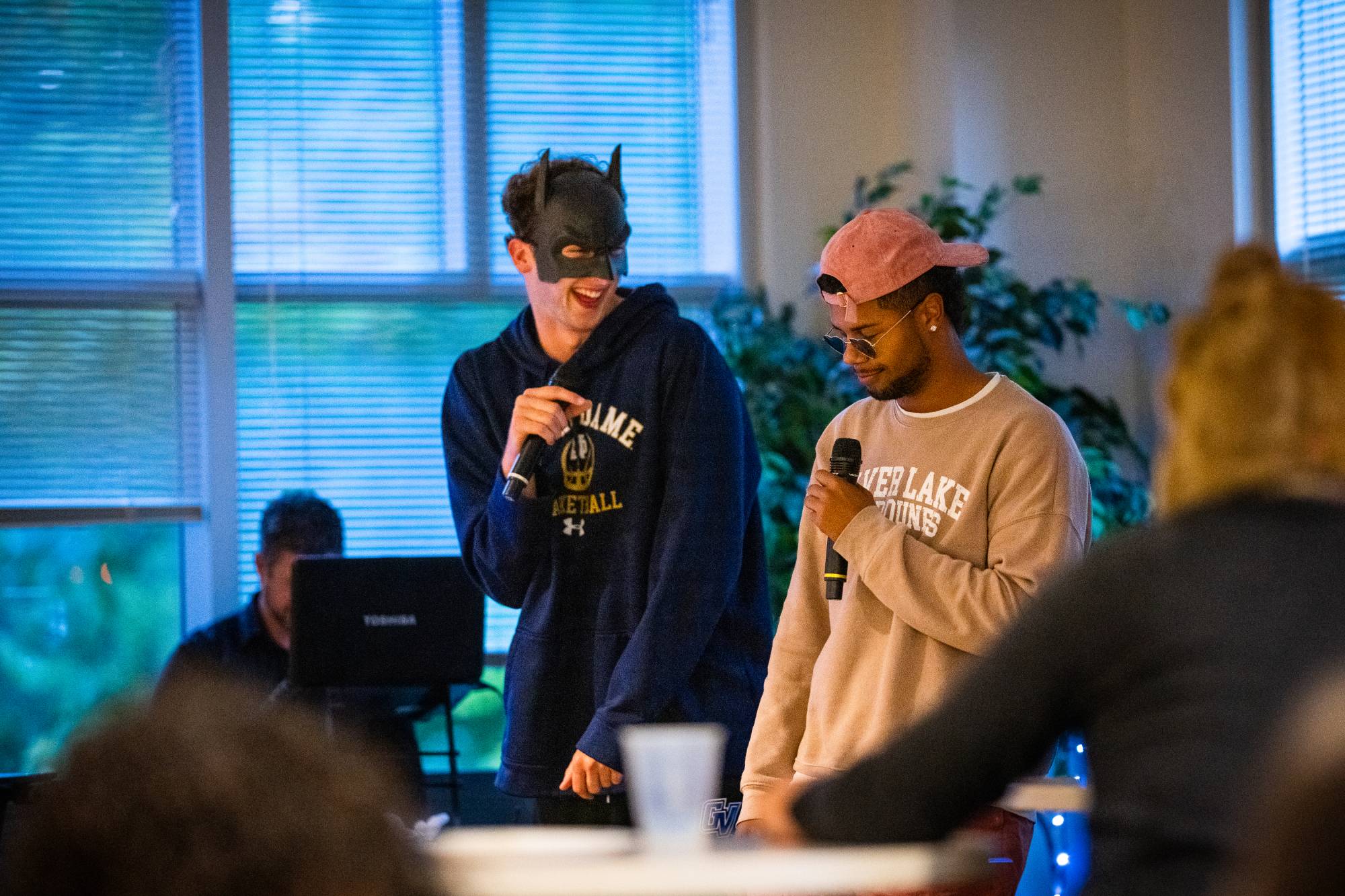 Students singing karaoke and smiling